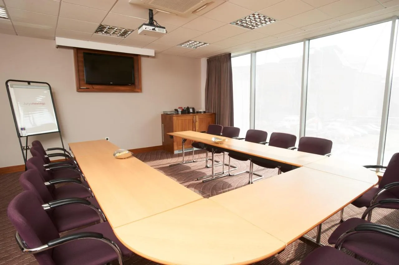 a conference room with a long table and chairs at Leonardo Hotel Aberdeen in Aberdeen